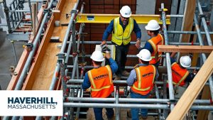 A construction crew working on scaffolding, assembling structural components in Haverhill, Massachusetts. Demonstrates teamwork, engineering, and urban development in the region.