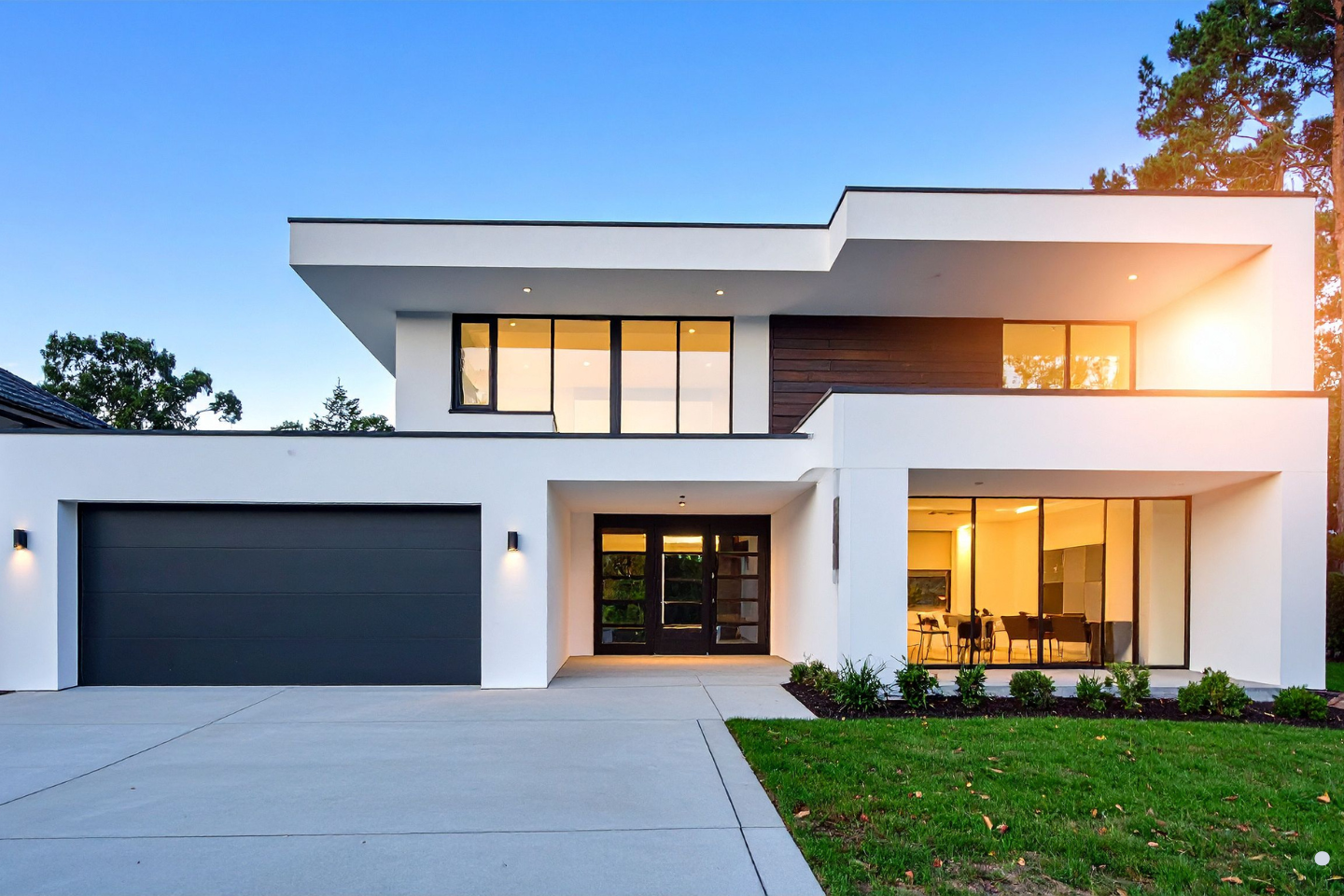 Modern two-story home with a clean concrete driveway, curb access, and completed exterior construction.