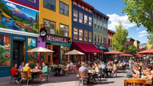Vibrant downtown Missoula, Montana, featuring colorful historic buildings, outdoor dining, and people enjoying the lively atmosphere on a sunny day.