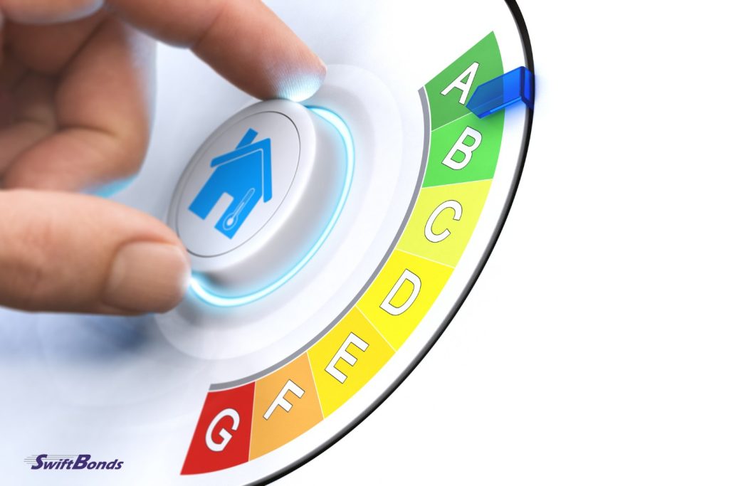 Hand-turning a knob to increase energy efficiency in a house.