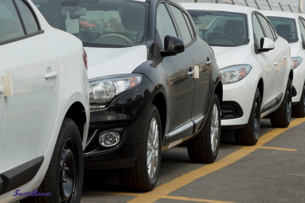 At the dealer shop, there were cars parked in black and white.