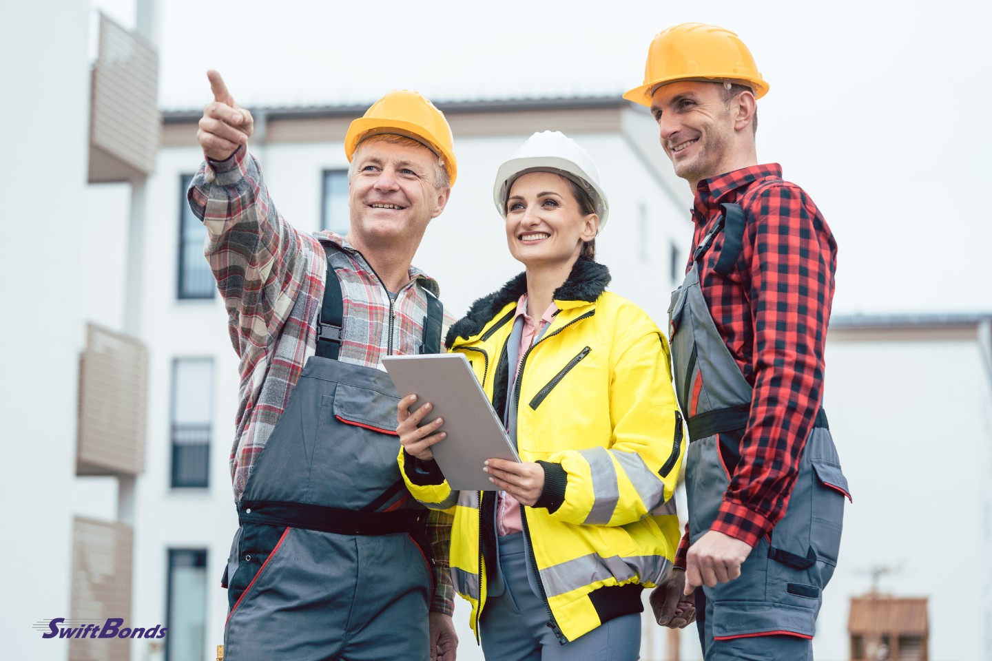 On a building site, a contractor and a builder assess new homes.