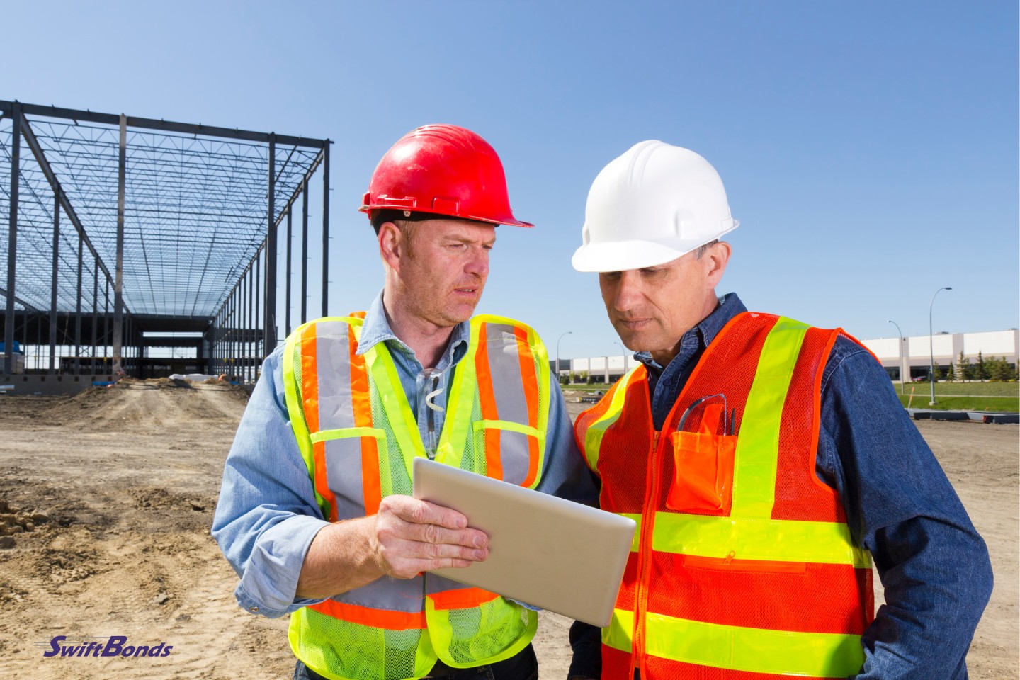 A picture of two construction contractors talking about the project.