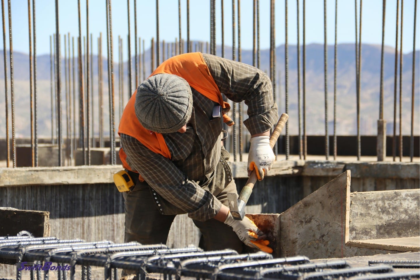 A hammer is being used by a construction worker.