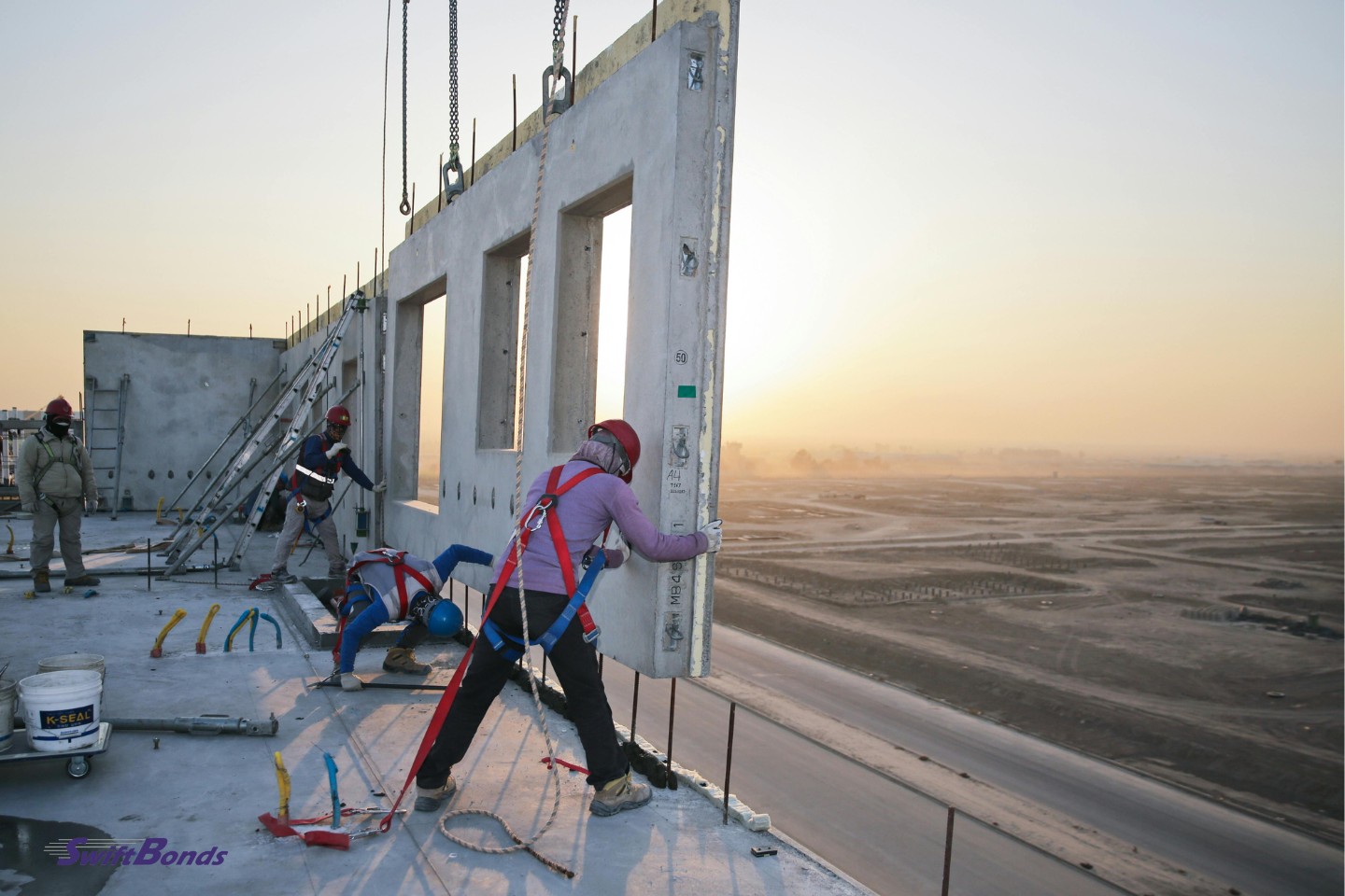 At dusk, builders are putting up reinforced concrete structures.