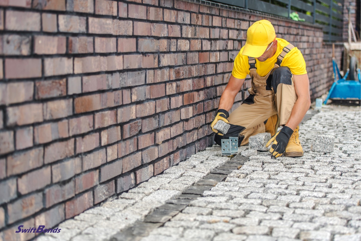 In the residential home's yard, a professional contractor has completed placing pavers on the driveway and along the fence.