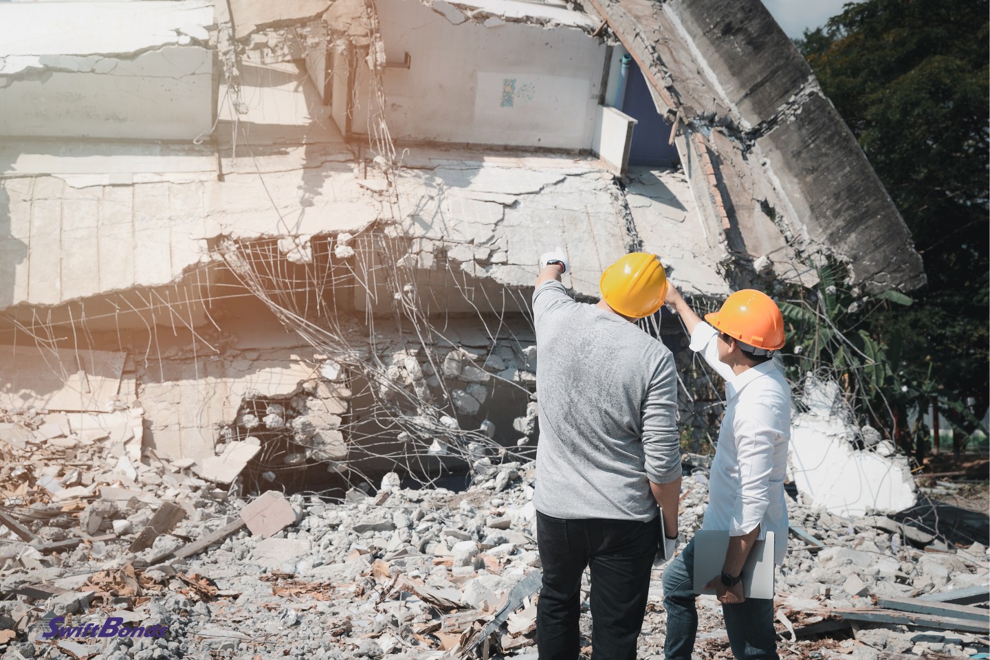 The contractor and the demolition control supervisor are talking about demolishing the structure.