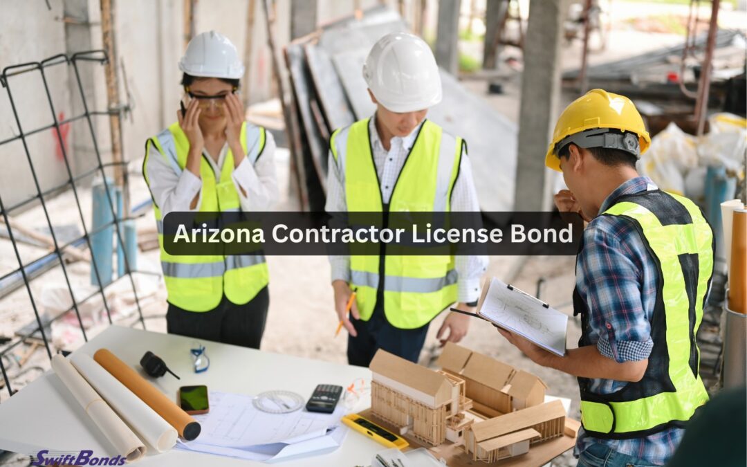 At the building under construction, three contractors wearing safety gear are going over the blueprints.