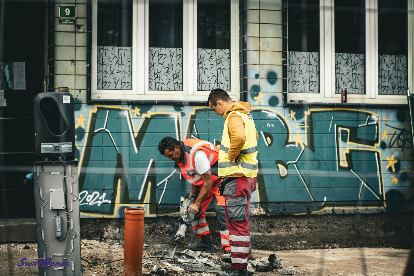 A worker in urban construction is repairing sidewalks.