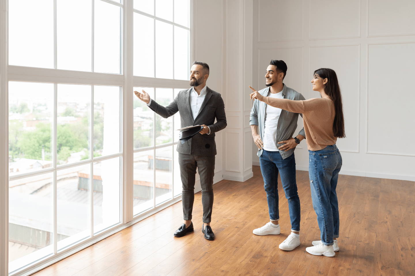 A real estate agent showing an empty commercial space to prospective tenants.