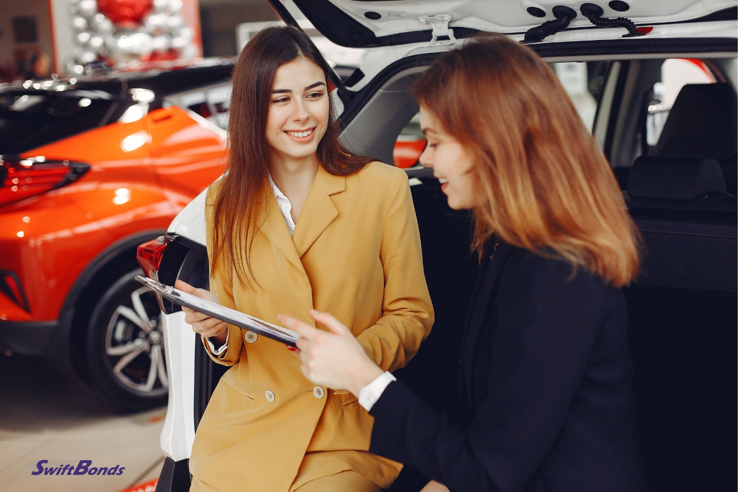 A customer is shown the contract by an amiable auto dealer.