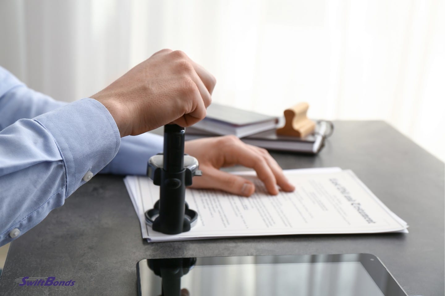 In the office, a notary public stamps documents.