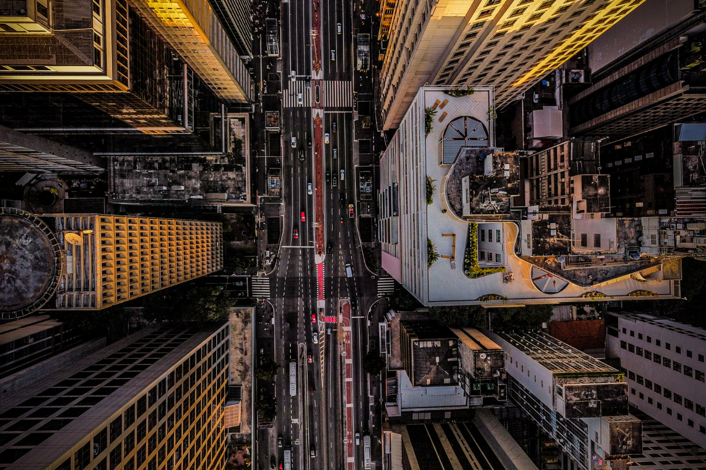 Aerial view of a busy downtown street surrounded by skyscrapers.
