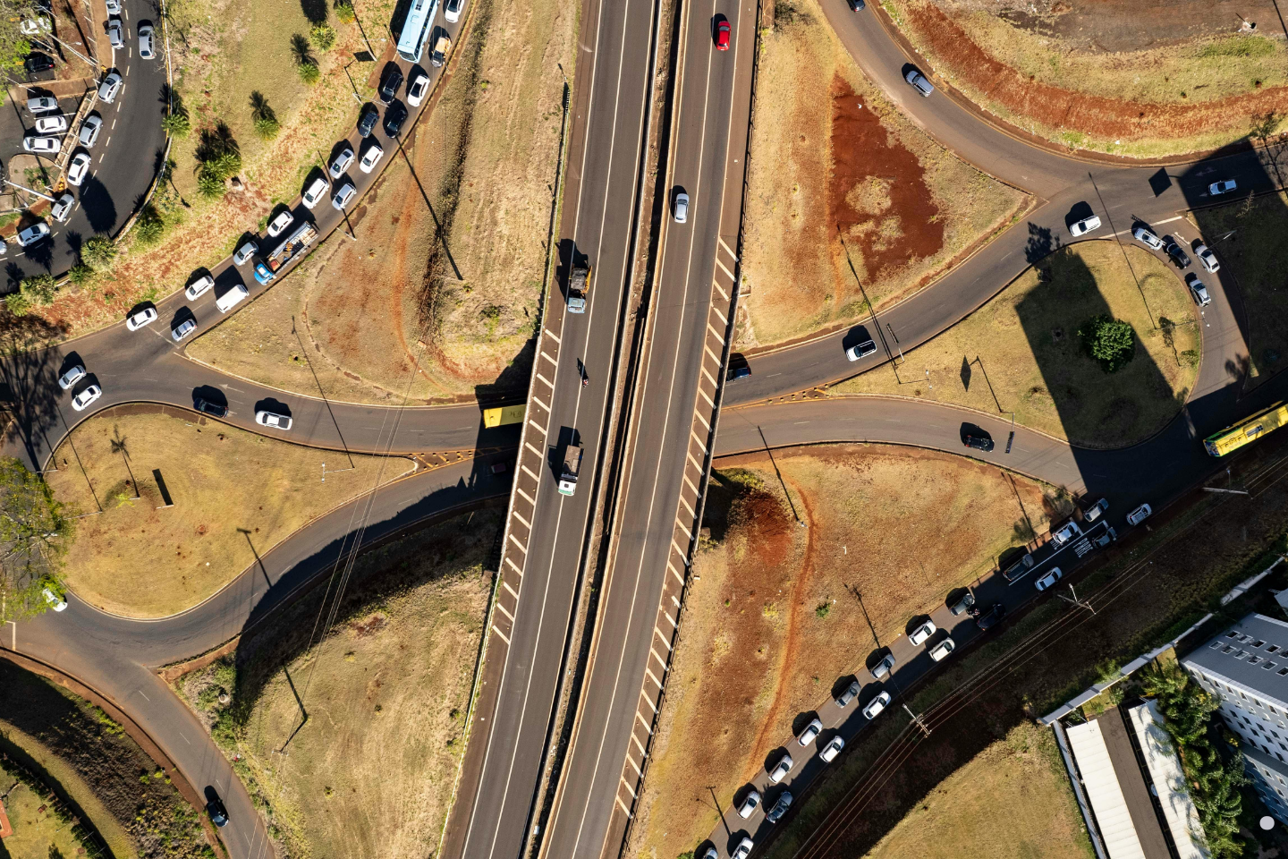 Aerial view of a busy highway interchange with cars traveling in multiple directions.