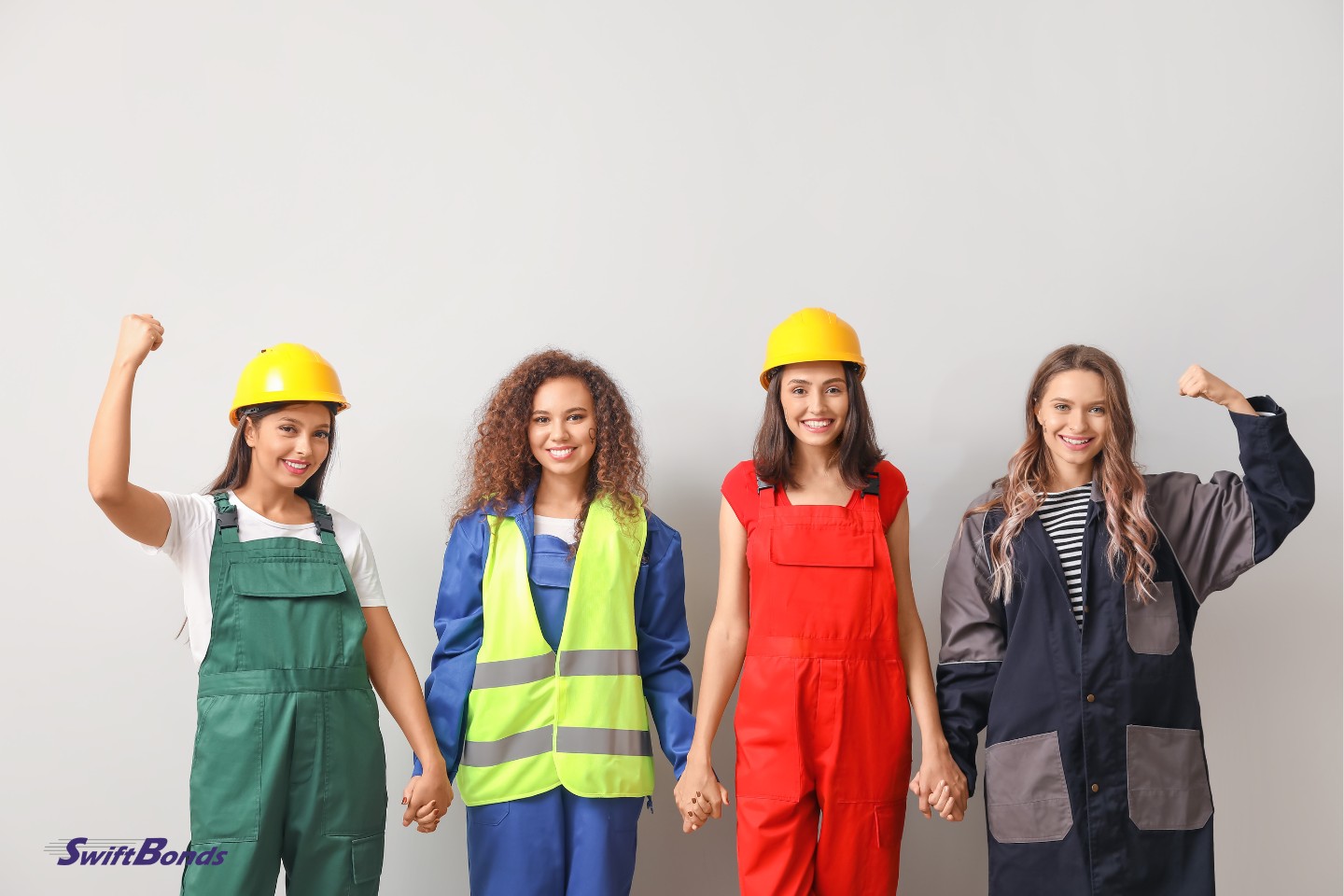 On a light background, female employees are wearing their uniforms and hardhats.