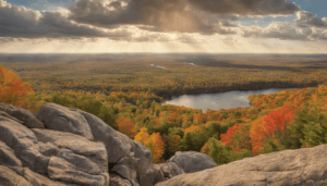 Scenic overlook near Wausau, Wisconsin showing a vast autumn forest and lake view, reflecting the city’s natural surroundings that often influence environmentally sensitive bonded construction projects.