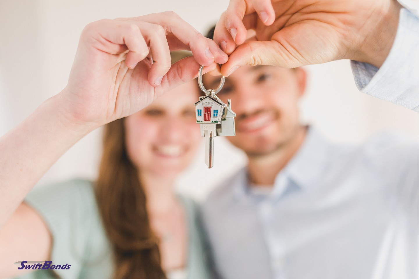 A happy couple with a house key in their hands.