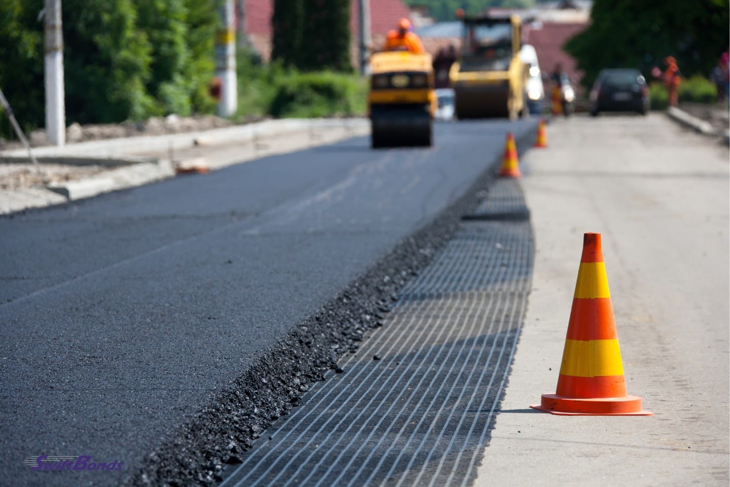 Asphalt paving with a flattening machine.