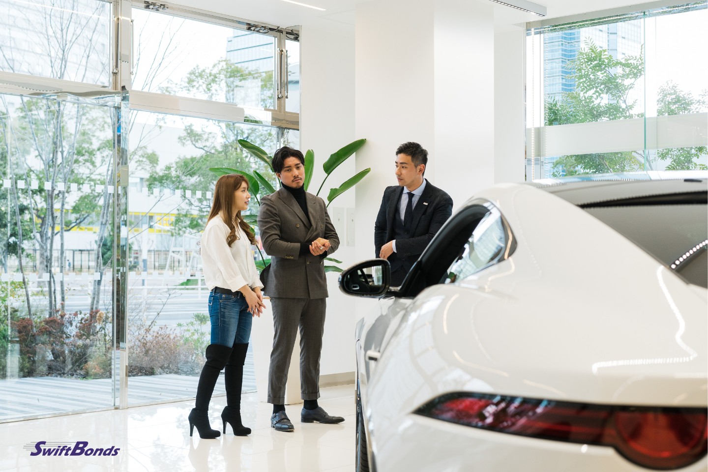 A couple at a car showroom selecting a vehicle.