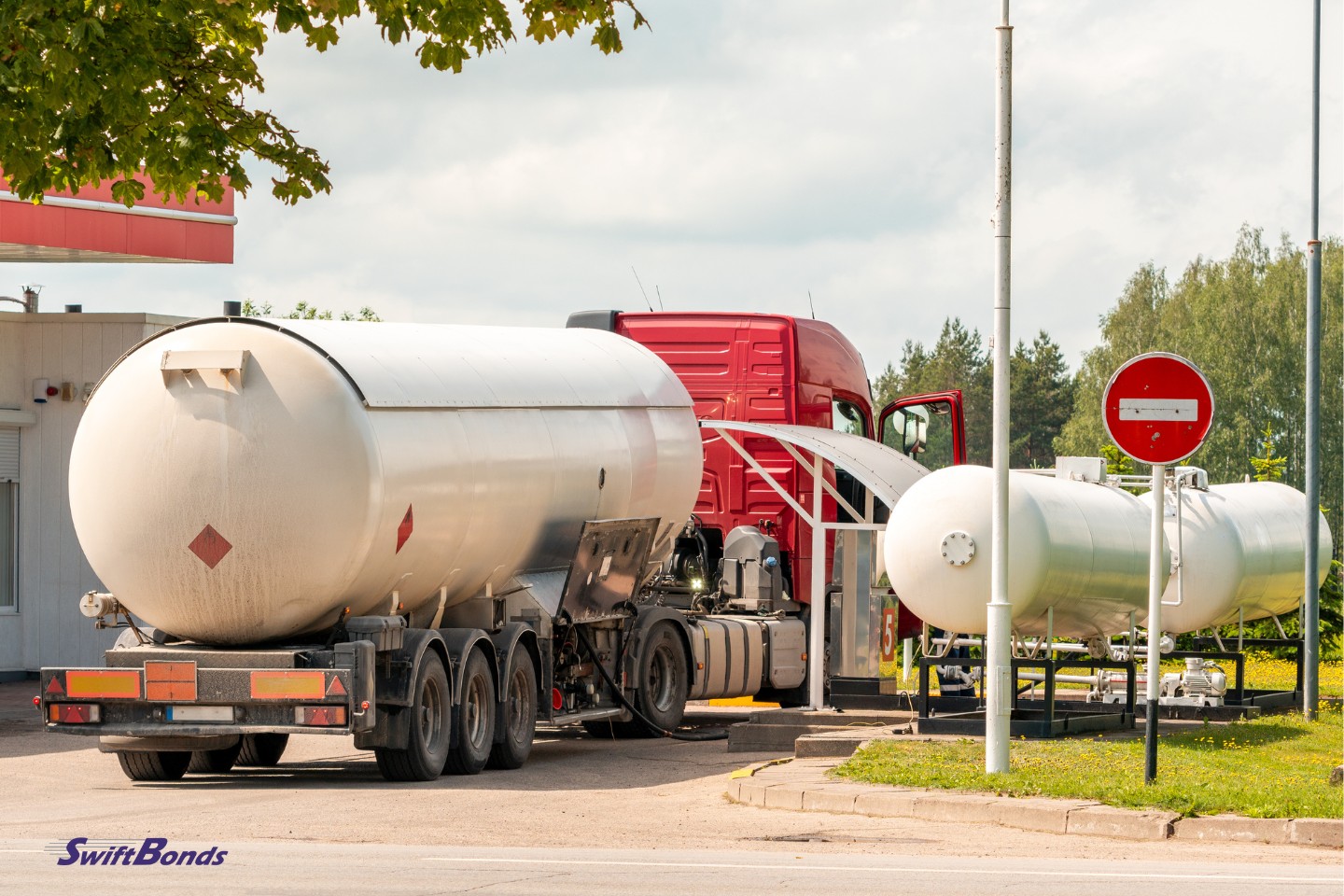 Tanker vehicle that transports propane or other fuel. Unloading at the gas station.