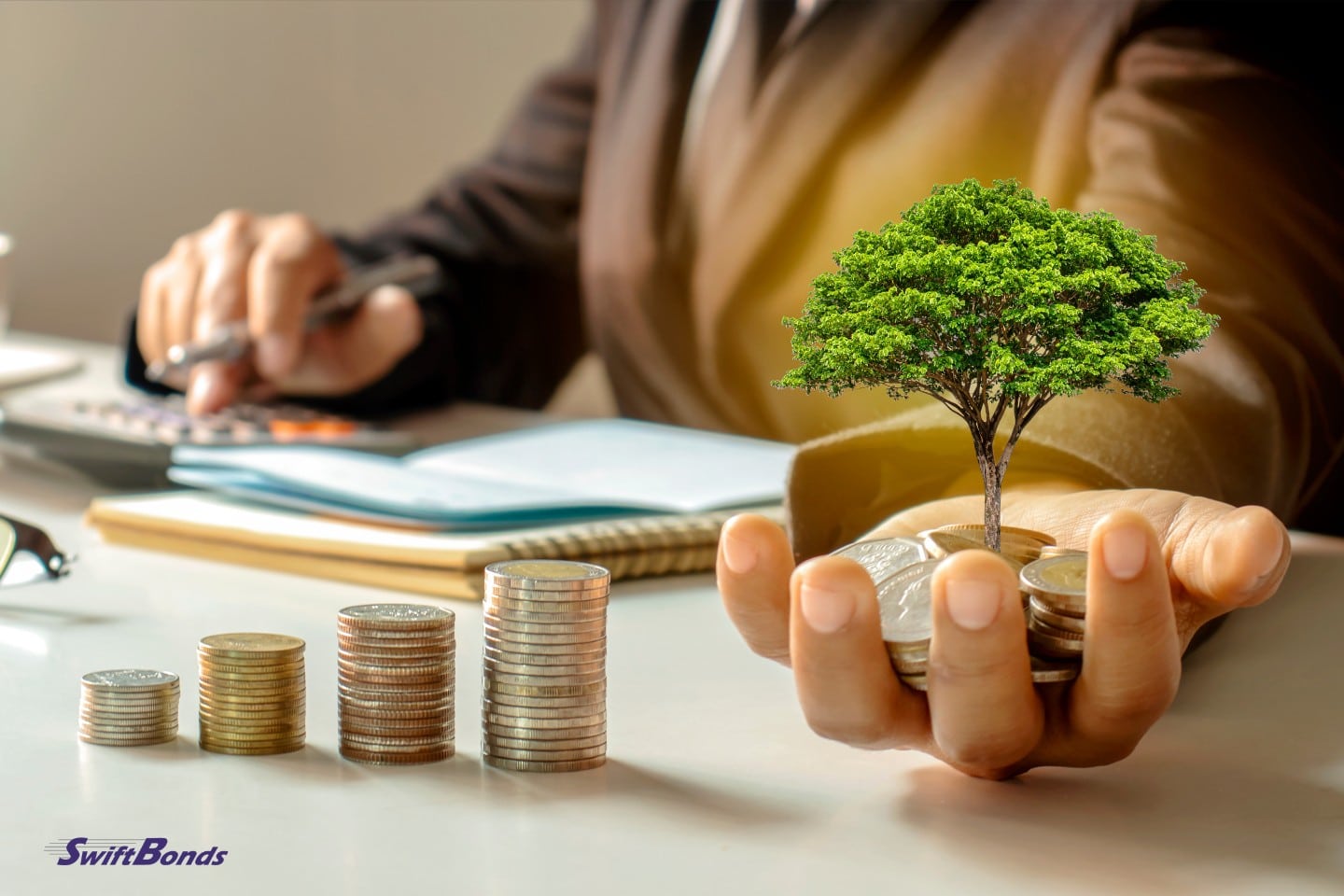 A businessman holds a growing tree.