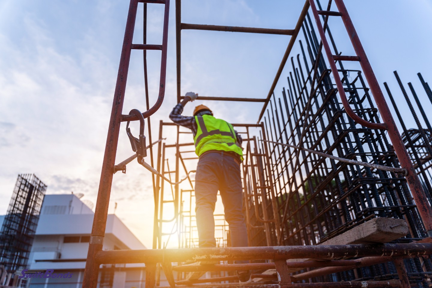 A contractor is wearing a safety vest and a hardhat.