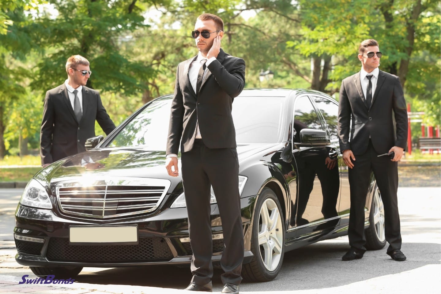 Handsome bodyguards bear a car outside.
