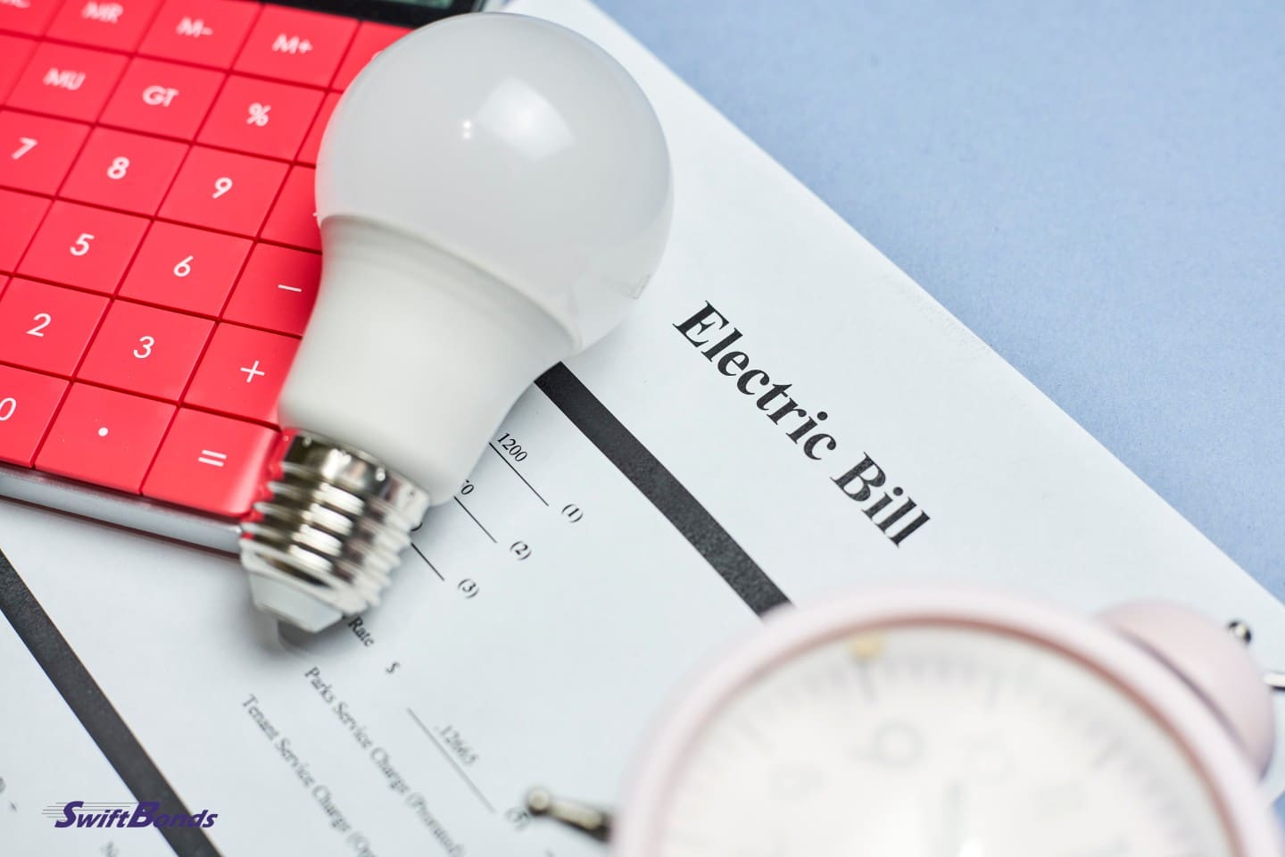 A clock, lightbulb, calculator, and monthly utility bills.