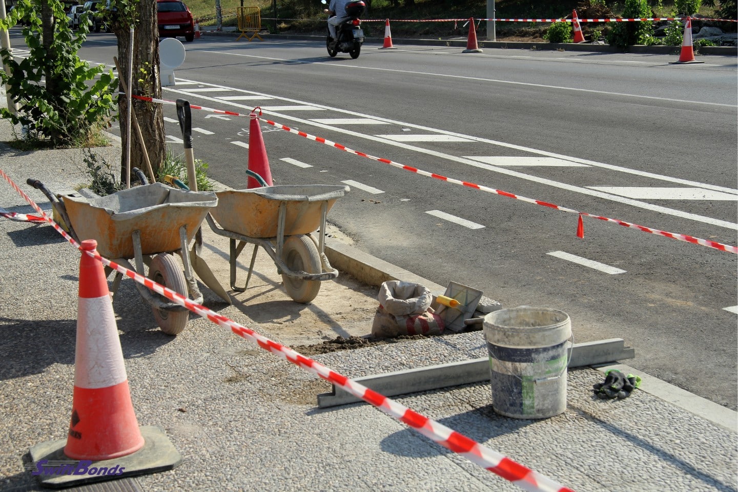 works on the pavement.  Orange cone and tools.
