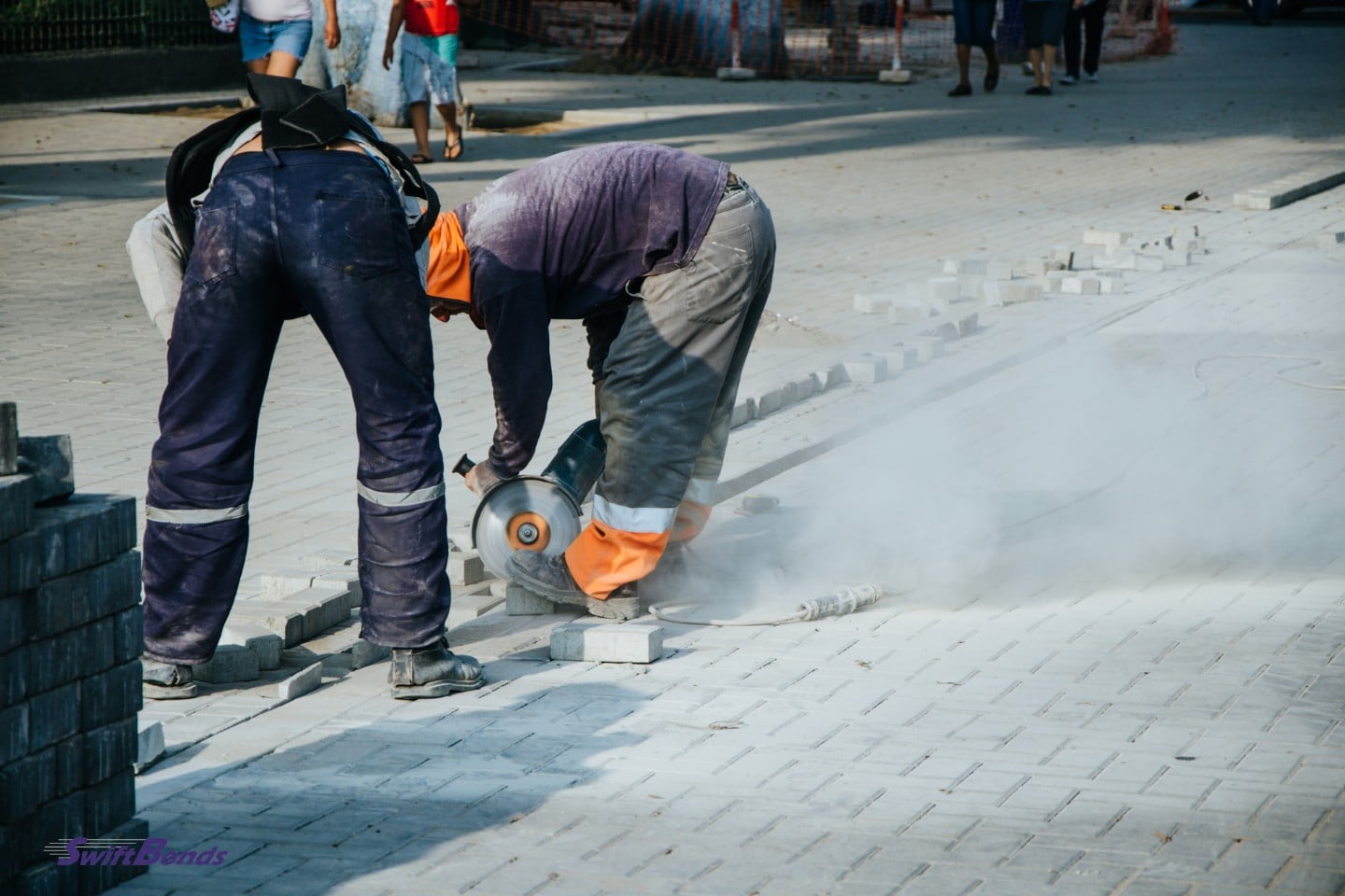 A sidewalk builder is working on a project.