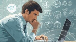 Illustration of a man working on a laptop with financial and logistics icons around him, symbolizing the steps required to get a freight broker bond.