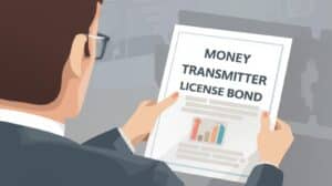 Close-up of a business professional reviewing a document labeled ‘Money Transmitter License Bond,’ symbolizing financial compliance and licensing preparation.