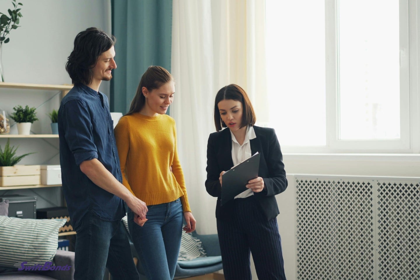 The representative shows the contract to a couple so they can sign it.