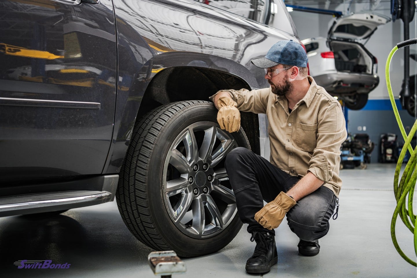 A mechanic inspects the condition of the tires.