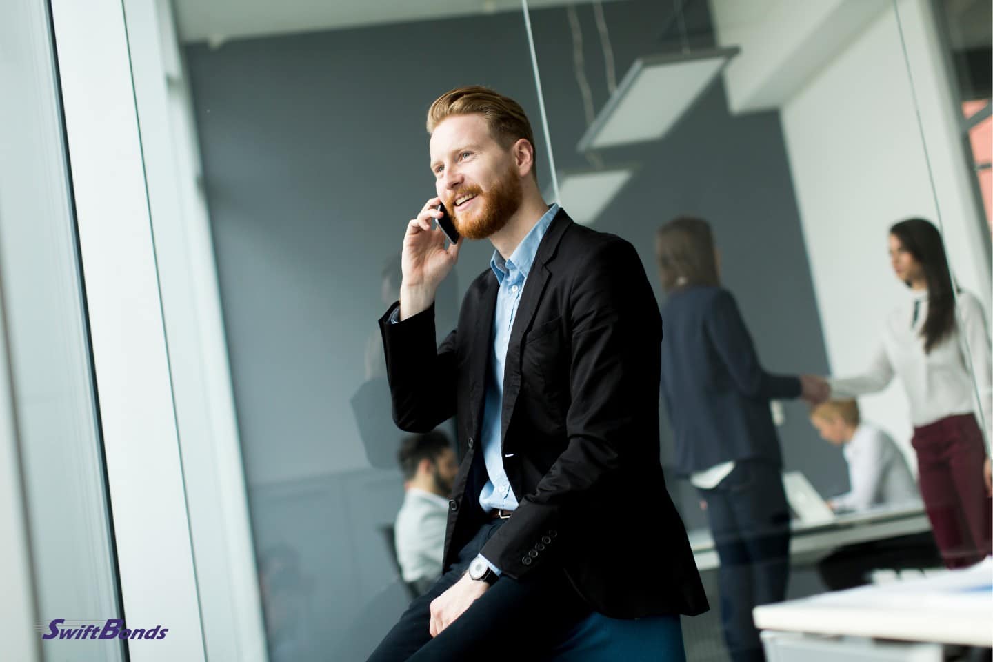 The agent is on his phone with someone.