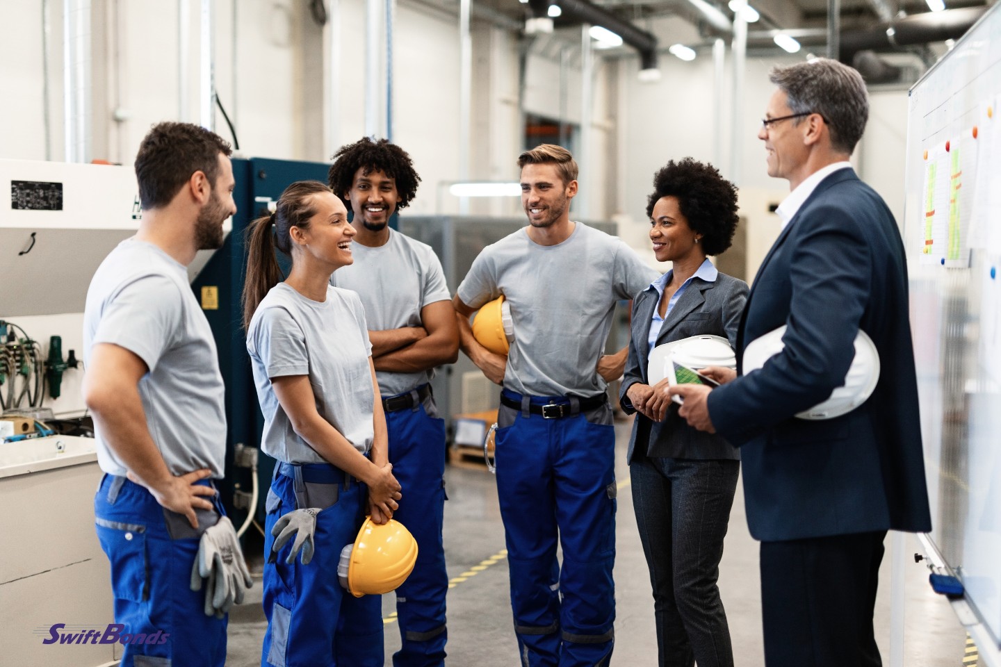 Young, contented employees chatting with plant bosses.