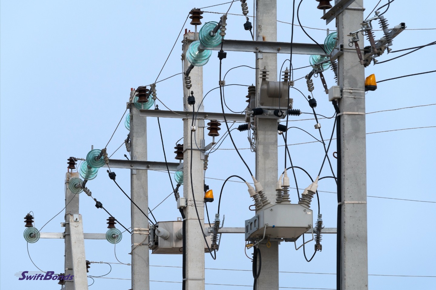 Blue sky with electrical towers in the backdrop.