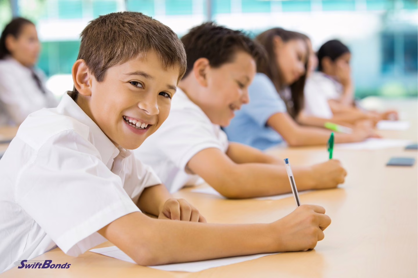 In the classroom, preteens are dressed in private school uniforms.