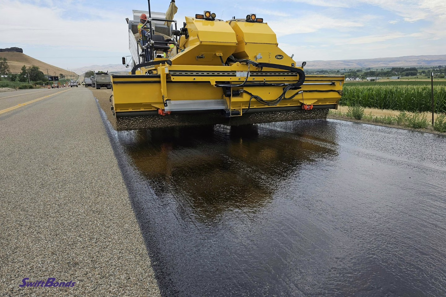 building of roads using a yellow asphalt machine.