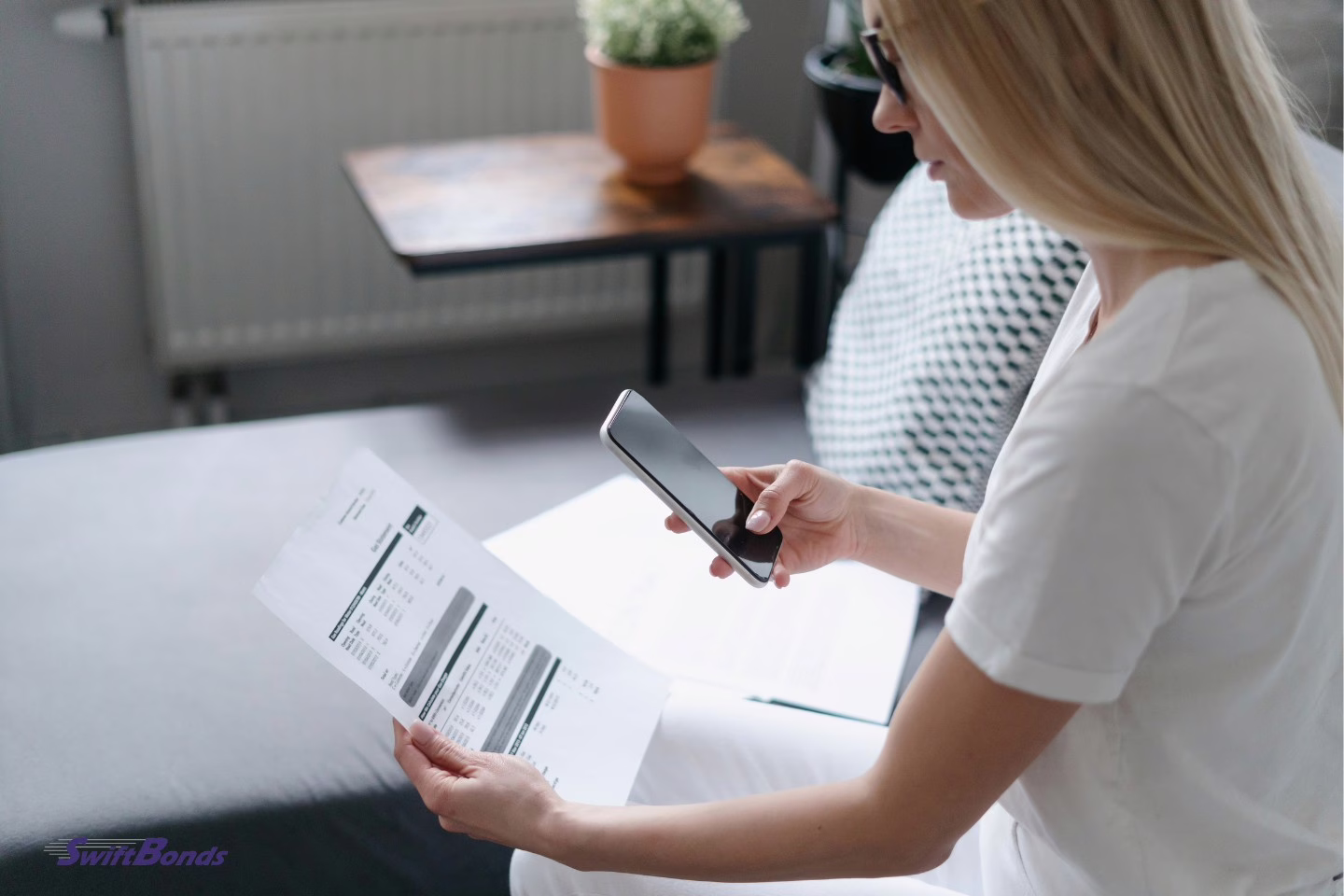 A woman uses her smart phone to pay after scanning her power bill.