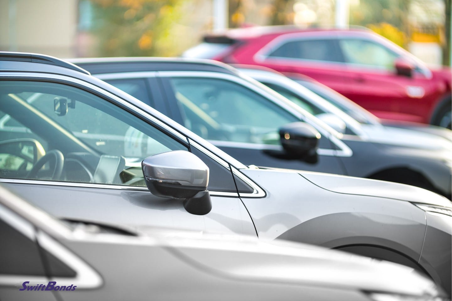 A side view of a modern, secondhand car at the dealership.