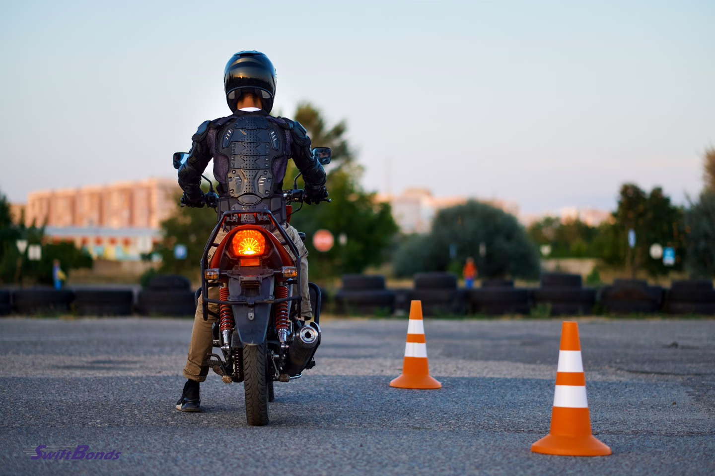Student on a motorbike, back view at the motorcycle school.