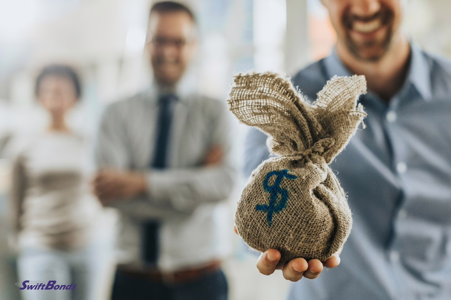 Close-up of a fundraiser professional holding a money bag.